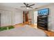 Bedroom with hardwood floors, ceiling fan, large dresser with a TV, and closet space at 950 Pineapple Rd, South Daytona, FL 32119