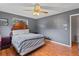 Bedroom features a ceiling fan, hardwood floors, a bed with headboard, and a window at 950 Pineapple Rd, South Daytona, FL 32119