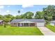 Charming single-story home with a welcoming front porch and lush green lawn at 950 Pineapple Rd, South Daytona, FL 32119