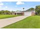 Charming brick home with front porch and long concrete driveway at 950 Pineapple Rd, South Daytona, FL 32119