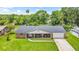 Charming single-story brick home with covered porch and well-manicured lawn at 950 Pineapple Rd, South Daytona, FL 32119