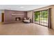 Inviting living room with a brick fireplace, tile floor, and sliding glass doors to backyard at 950 Pineapple Rd, South Daytona, FL 32119