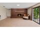Inviting living room features a cozy brick fireplace and a sliding glass door to the outdoors at 950 Pineapple Rd, South Daytona, FL 32119