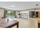 Open living space with kitchen, tile floors, large window overlooking pool, and a dining table at 950 Pineapple Rd, South Daytona, FL 32119