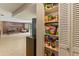 View of the living room from the pantry, filled with an array of snacks and other food at 950 Pineapple Rd, South Daytona, FL 32119