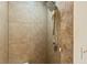 Close up of the bathroom shower, showcasing tan tile with a rain shower fixture at 950 Pineapple Rd, South Daytona, FL 32119