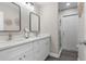 Bright bathroom features a double vanity with white cabinets, modern faucets, and a glass-enclosed shower at 105 Bonita Pl, Ormond Beach, FL 32174