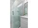 Beautiful glass shower with marble tile, rain shower head, and stylish vanity at 105 Bonita Pl, Ormond Beach, FL 32174