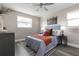 Stylish bedroom features a gray headboard, gray walls, gray flooring, and two windows at 105 Bonita Pl, Ormond Beach, FL 32174