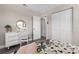 Cozy bedroom features a dresser, a writing desk and a double-door closet at 105 Bonita Pl, Ormond Beach, FL 32174