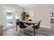 Dining area with sleek gray floors, neutral walls, and view to backyard at 105 Bonita Pl, Ormond Beach, FL 32174