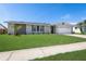 Inviting single-story home with a well-manicured lawn, fresh exterior paint, and tidy landscaping at 105 Bonita Pl, Ormond Beach, FL 32174