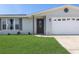 Close up of front door and garage of charming home at 105 Bonita Pl, Ormond Beach, FL 32174