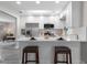 Bright kitchen with white cabinets, stainless steel appliances, and breakfast bar seating at 105 Bonita Pl, Ormond Beach, FL 32174