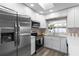 Well-lit kitchen features stainless appliances, white cabinets, and countertop seating at 105 Bonita Pl, Ormond Beach, FL 32174