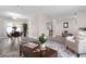 Open floor plan living room with gray floors, natural light, and comfortable seating at 105 Bonita Pl, Ormond Beach, FL 32174