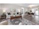 Cozy living room showcasing stylish furniture, a patterned rug, and a glimpse into the dining area at 105 Bonita Pl, Ormond Beach, FL 32174