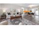 Living room showcasing stylish furniture, a patterned rug, and a glimpse into the dining area at 105 Bonita Pl, Ormond Beach, FL 32174