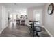 Open living space showcases sleek flooring, kitchen access, and a stylish table with barstool seating at 105 Bonita Pl, Ormond Beach, FL 32174