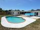 Inviting kidney-shaped pool with brick trim and concrete patio, perfect for outdoor relaxation and entertaining at 105 Bonita Pl, Ormond Beach, FL 32174