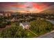 An aerial view of a classic home with mature trees and proximity to beachside hotels at 1221 Gamble Pl, Daytona Beach, FL 32118