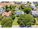 An aerial view of a well-maintained property with mature landscaping and a detached garage at 1221 Gamble Pl, Daytona Beach, FL 32118