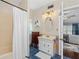 Bathroom with blue tiled floor, shower with curtain, and vanity with storage at 1221 Gamble Pl, Daytona Beach, FL 32118