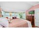 Bedroom featuring multiple windows, hardwood floors, and a television at 1221 Gamble Pl, Daytona Beach, FL 32118