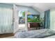 Light-filled bedroom with an open door to a deck, nice floors and plenty of light at 1221 Gamble Pl, Daytona Beach, FL 32118