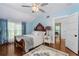 Comfortable bedroom featuring hardwood floors, blue walls, and natural light at 1221 Gamble Pl, Daytona Beach, FL 32118