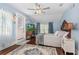 Charming bedroom with hardwood floors, ceiling fan, and doorway to the deck at 1221 Gamble Pl, Daytona Beach, FL 32118