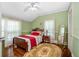 Inviting bedroom with hardwood floors, ceiling fan, and natural light at 1221 Gamble Pl, Daytona Beach, FL 32118