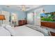 Bright bedroom featuring a doorway, hardwood floors, and an adjacent bathroom at 1221 Gamble Pl, Daytona Beach, FL 32118