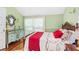 Comfortable bedroom with vintage furniture, hardwood floors, and ample natural light at 1221 Gamble Pl, Daytona Beach, FL 32118