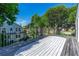 Spacious wooden deck with ornate railing and a view of the landscaped backyard at 1221 Gamble Pl, Daytona Beach, FL 32118