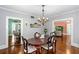 Formal dining room showcasing wood floors and seamless flow to adjacent living spaces at 1221 Gamble Pl, Daytona Beach, FL 32118