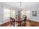 Elegant dining room features wood floors, a decorative chandelier, and large windows at 1221 Gamble Pl, Daytona Beach, FL 32118