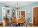 Inviting dining room showcasing hardwood floors, elegant light fixture, and access to the kitchen at 1221 Gamble Pl, Daytona Beach, FL 32118