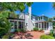 Exterior view of the house with brick patio and lush, green foliage at 1221 Gamble Pl, Daytona Beach, FL 32118