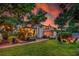 Beautiful home at twilight with illuminated outdoor areas and landscape at 1221 Gamble Pl, Daytona Beach, FL 32118
