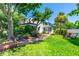 Charming two-story home with a lush landscaped yard and brick pathway at 1221 Gamble Pl, Daytona Beach, FL 32118