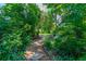 Enchanting stone path surrounded by lush greenery and tropical foliage at 1221 Gamble Pl, Daytona Beach, FL 32118