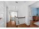 Bright hallway with hardwood floors, white trim, and natural light from window at 1221 Gamble Pl, Daytona Beach, FL 32118