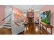 A living room showing the stairs, fireplace, hardwood floors, and large sofa at 1221 Gamble Pl, Daytona Beach, FL 32118