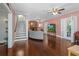 Bright living room with hardwood floors, a cozy fireplace, elegant staircase, and french doors at 1221 Gamble Pl, Daytona Beach, FL 32118