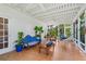 Large screened-in porch offering a relaxed living space with tiled floor and fan at 1221 Gamble Pl, Daytona Beach, FL 32118