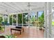 Screened porch with comfortable seating and view of the lush landscaping at 1221 Gamble Pl, Daytona Beach, FL 32118
