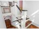 Elegant staircase featuring hardwood steps, white railings, and classic architectural details at 1221 Gamble Pl, Daytona Beach, FL 32118