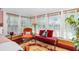 Cozy sunroom featuring vintage furniture, large windows, and bright natural light at 1221 Gamble Pl, Daytona Beach, FL 32118