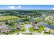 Aerial view of home with solar panels in a lakeside residential community at 1904 Rouzbeh Ct, Port Orange, FL 32128